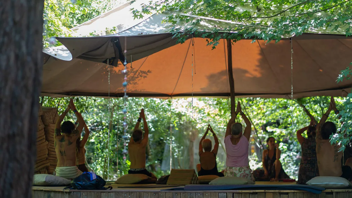 A circle under the canvas shade, arms raised