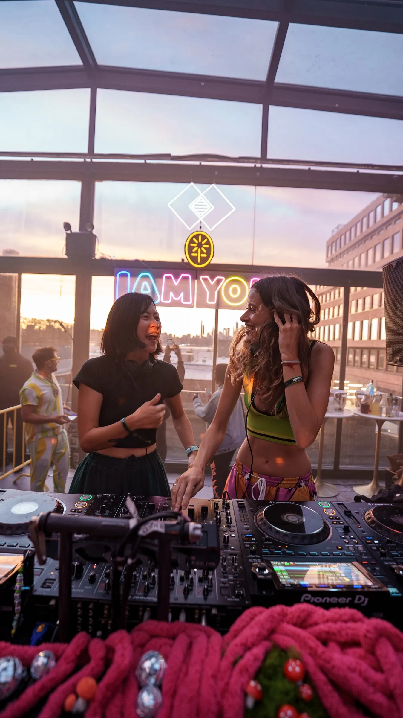 Two people sharing a moment behind the DJ booth
