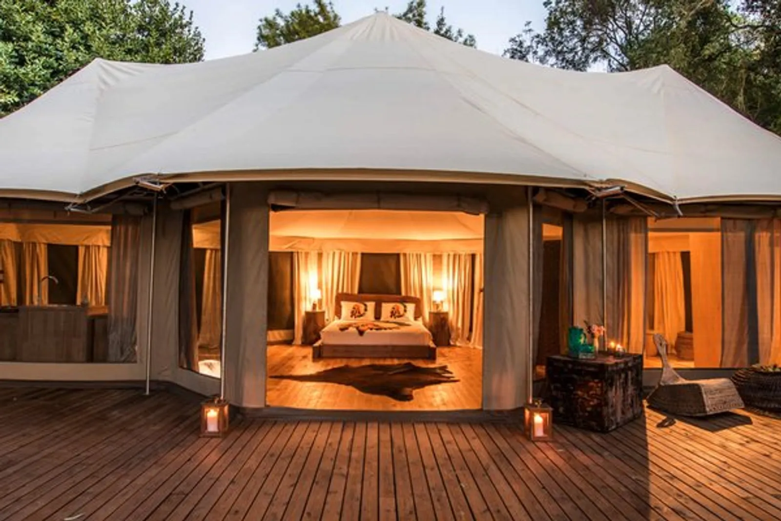 Safari Suite: a lit canvas suite on a wooden deck at dusk