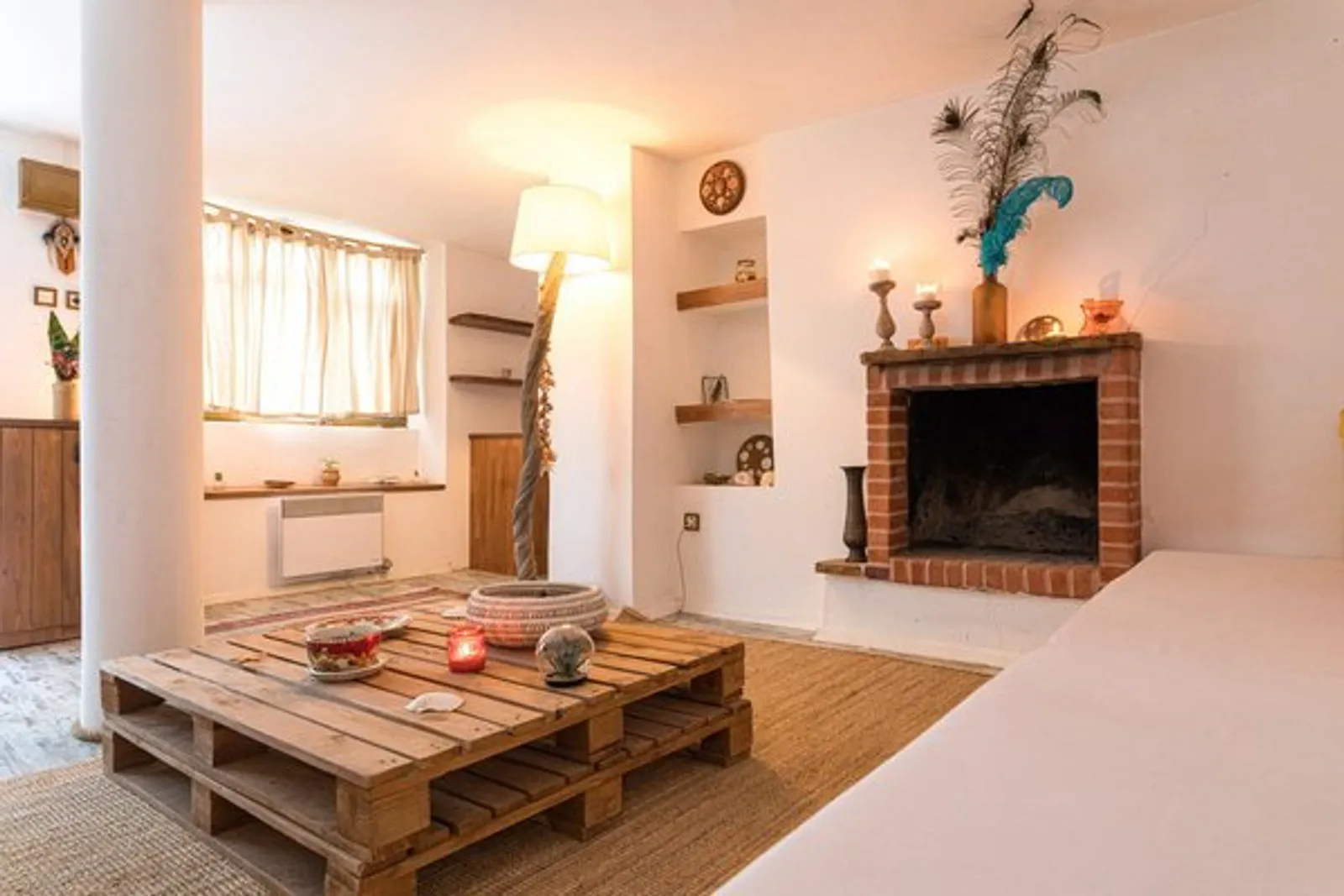 Stone House Suite: whitewashed living room with a fireplace