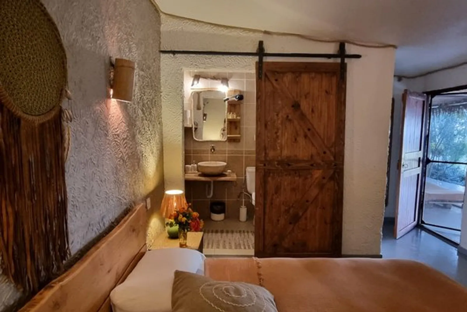 Sea-front Room: bedroom with a sliding barn door to the bathroom