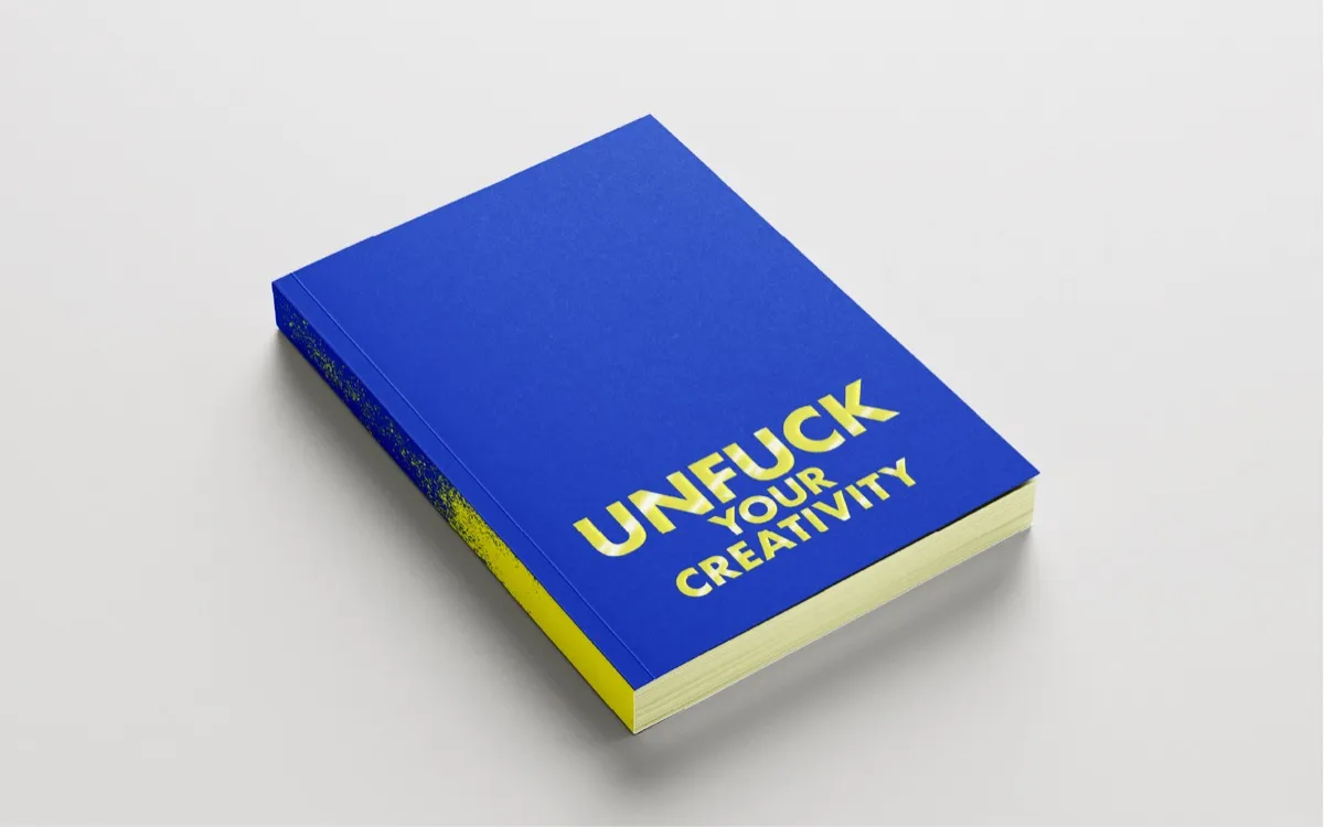 The blue and acid-yellow Unfuck Your Creativity book.