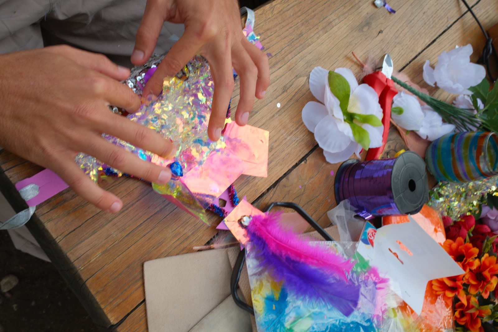 A close view of hands working on a craft project