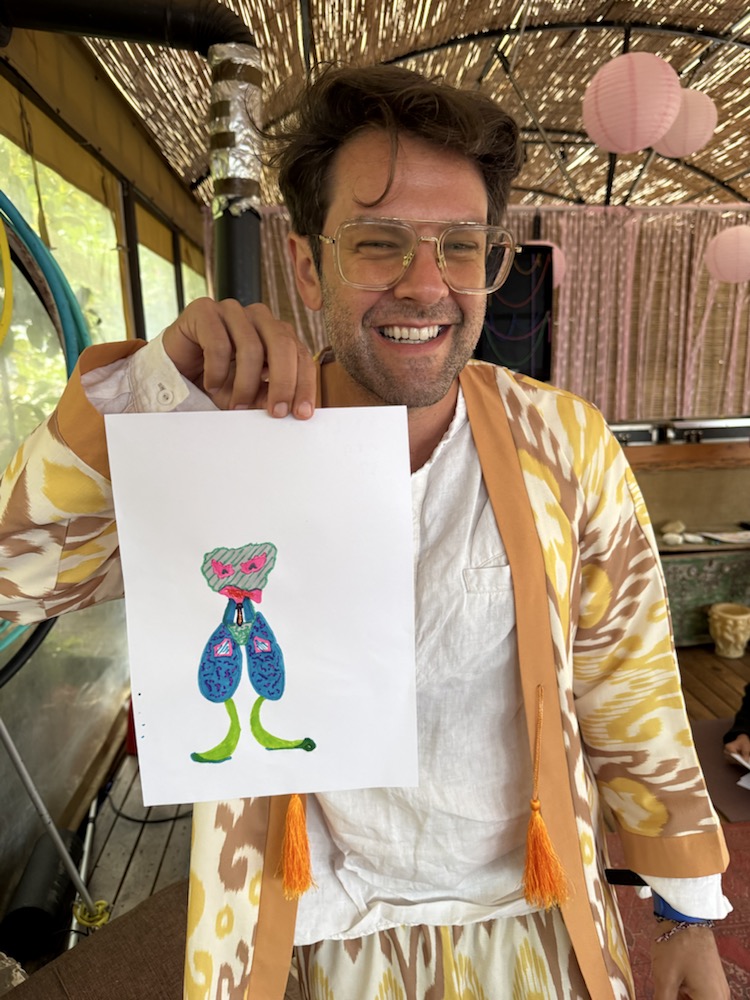 Participant holding a small blue alien drawing